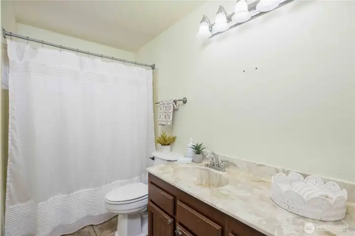 Hallway bathroom with a bathtub.