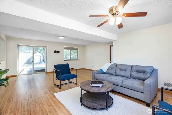Downstairs bonus room with a total of three windows and a sliding glass door.