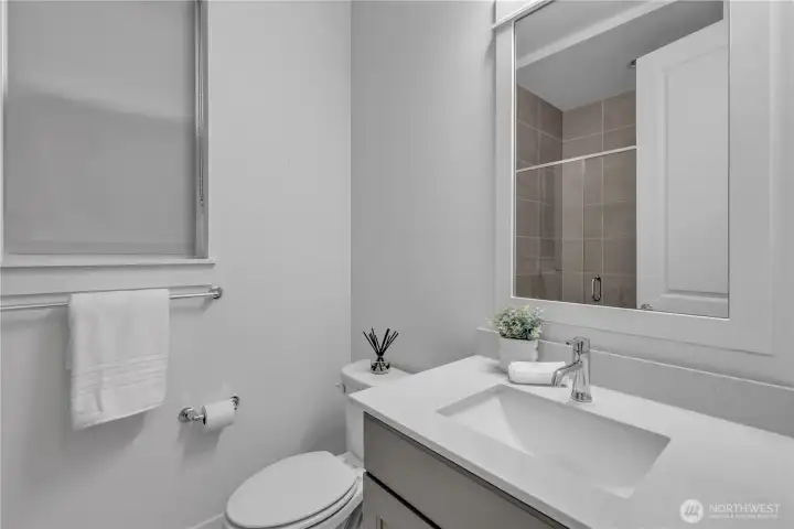 Main level three quarter bathroom/powder room. Main level three quarter bathroom/powder room.