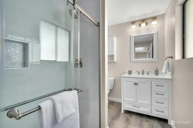 Ooolala! Completely updated, inviting Primary bath. Everything is new including the gorgeous tiled shower, vanity, fixtures and flooring!