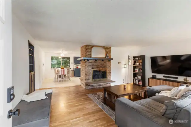 Glowing hardwoods add tremendous character and a warm atmosphere to the home.  Note the Double sided fireplace with beautiful wrap-around Mantle and 2 hearths!