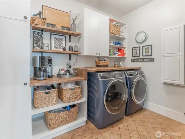 Laundry room with linen cabinets ,folding counter & tile floors