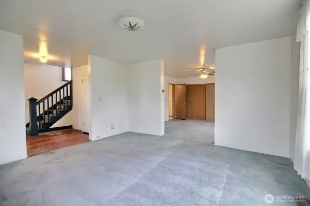 Living room pass through to the dining room and open entry door to the kitchen be seen.