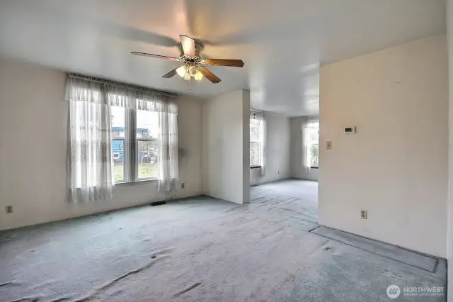 Oversized dining room with large windows looks out over the large parcel to the south.