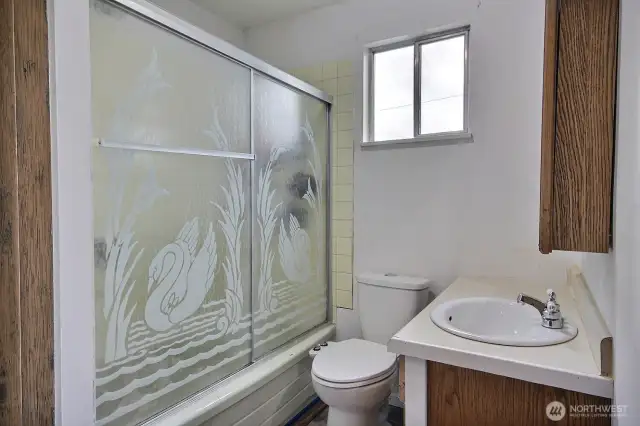 Main floor Full bath features a tub/shower and new LVP flooring.