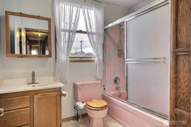 2nd level full bath with tub shower and deep storage/linen cabinet on the right.