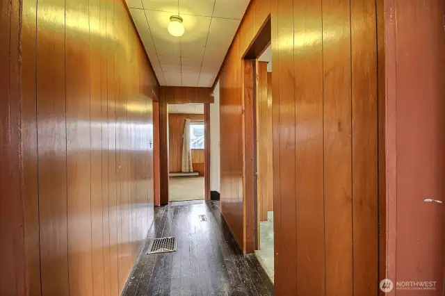 Upper level features wood paneled hallway and original fir flooring.