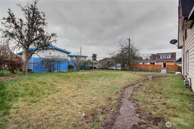 Large side yard/2nd parcel is fully fenced and features mature apple, pear and plum trees.