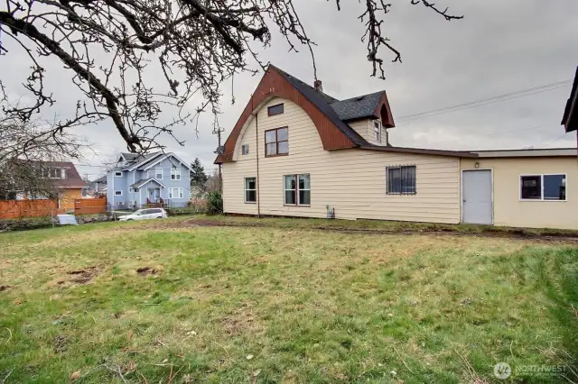 The large fully fenced lot has mature trees, two storage sheds, and plenty of space for gardening or future expansion.
