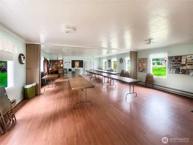 This expansive room is incredibly versatile, accommodating gatherings, dining, a workshop, classes, and a multitude of other activities