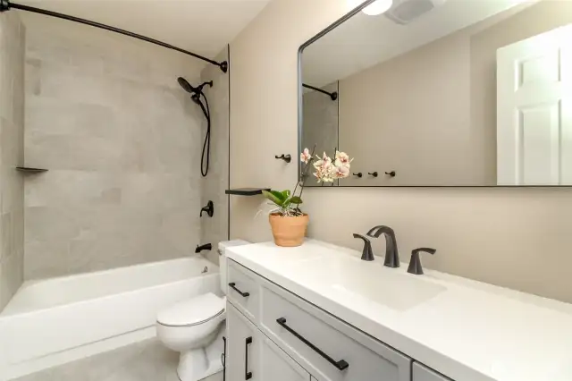Hall full bath w/  new tile rain shower & vanity