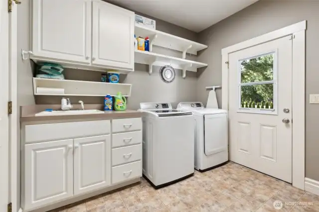 Utility room with uppers and lowers and room for spare freezer and refridgerator behind photographer