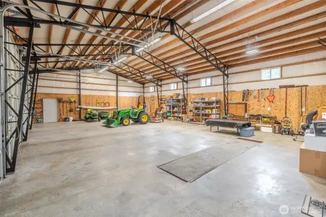 Inside 66 x 36' shop. Insulated, 220V, Air compressor lined around interior perimeter, grease pit in middle of picture for working on vehicles.