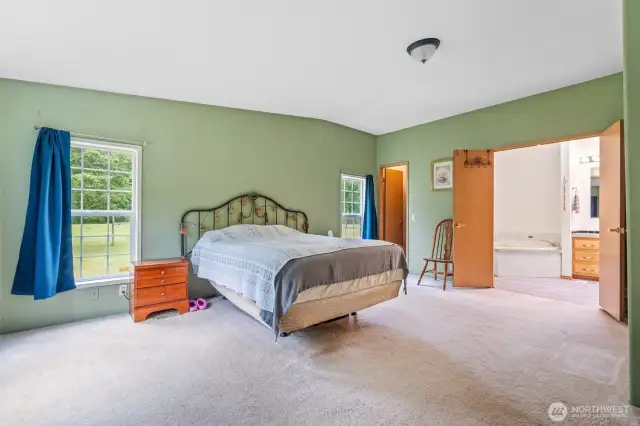 Primary bedroom with french doors to bright & open bathroom