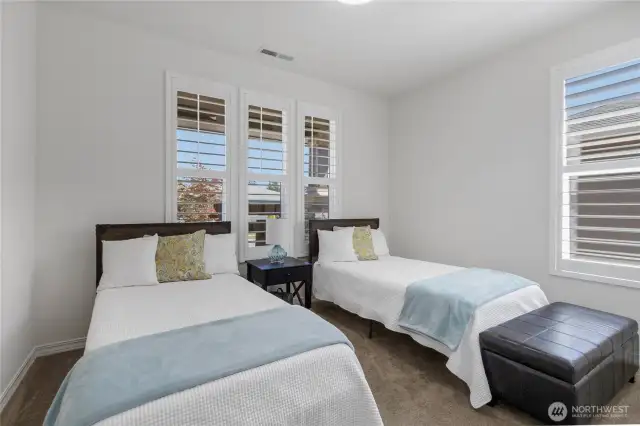 2nd bedroom privately located at the far-end of the home (away from the owner's suite) has generous space, large closet and main view of the precious front porch (not the neighbor's house).