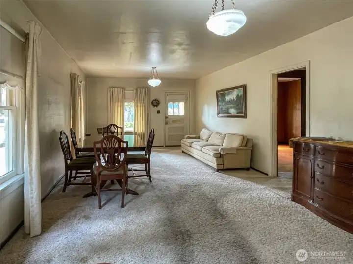Doorway on the right leads to primary bedroom, hall bath and stairs to upper level
