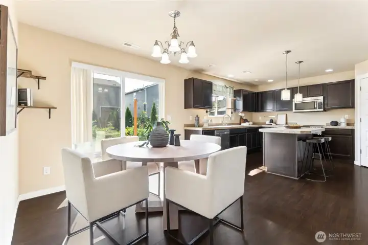 kitchen flows to  a spacious dining area, includes plenty of natural light