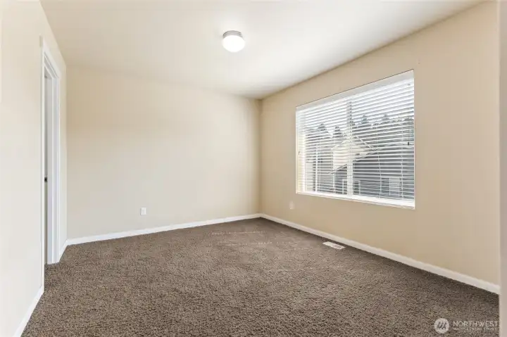 upstairs bedroom with walk in closet also with attached jack and jill bath