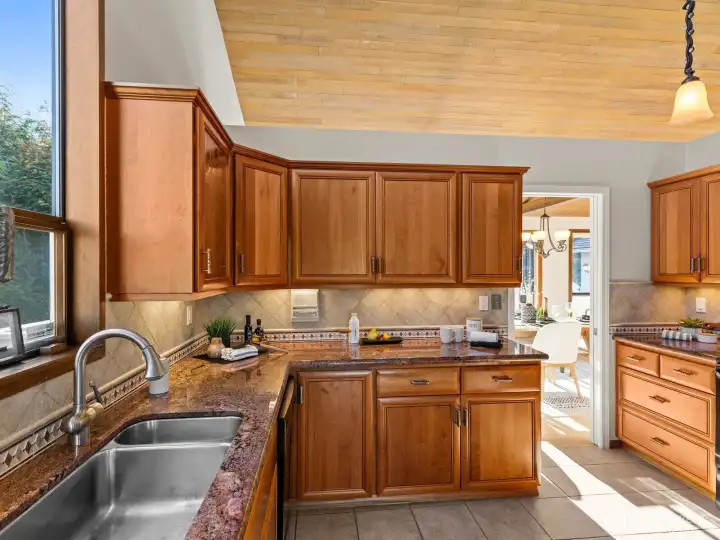The thoughtful floorplan flows seamlessly into elegant kitchen where you'll find custom cabinetry, maximizing the storage and counter space for all of your cooking and baking needs.