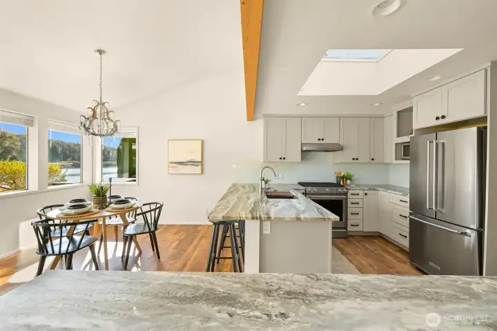 A view of the kitchen and breakfast nook from the formal dining/great room.