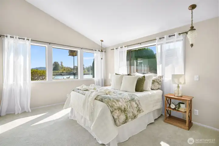 The primary bedroom has a gorgeous view and ensuite bath with step-in shower