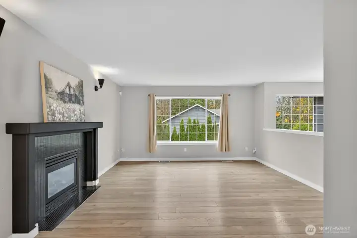 Inviting main-level living area with large windows, gas fireplace, and an open layout ideal for both relaxing and entertaining.