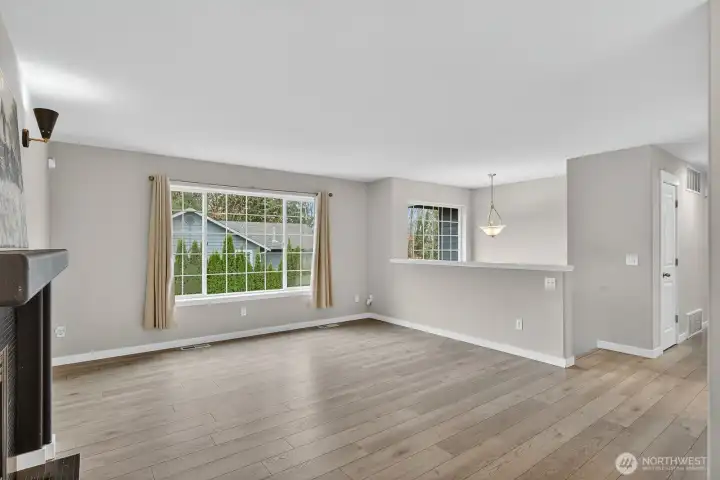 Spacious and light-filled living room featuring a cozy gas fireplace—the perfect spot to gather and unwind.