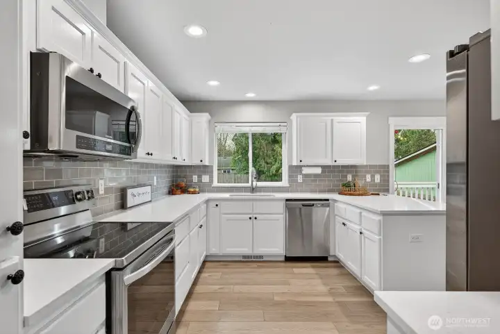 Stunning kitchen with abundant cabinetry, generous counter space, and sleek quartz surfaces ready for your culinary creations.