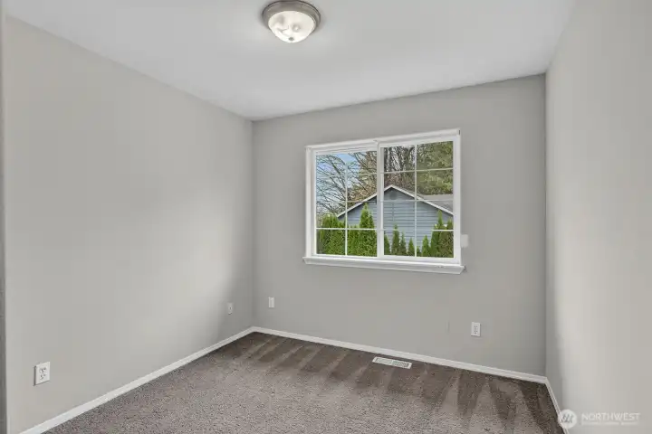 Guest Bedroom 2: Secondary bedroom on the upper level with large windows and a relaxing atmosphere.