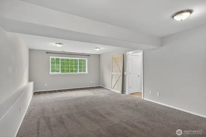 Huge downstairs living area with plenty of room to spread out, featuring flexible space for entertaining or relaxing.