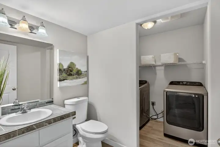 Convenient lower-level half bath with attached laundry area—perfectly located for daily functionality and easy access.