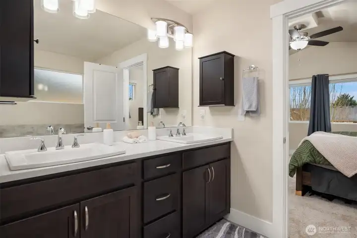 His and hers spa bath with slab quartz countertops.