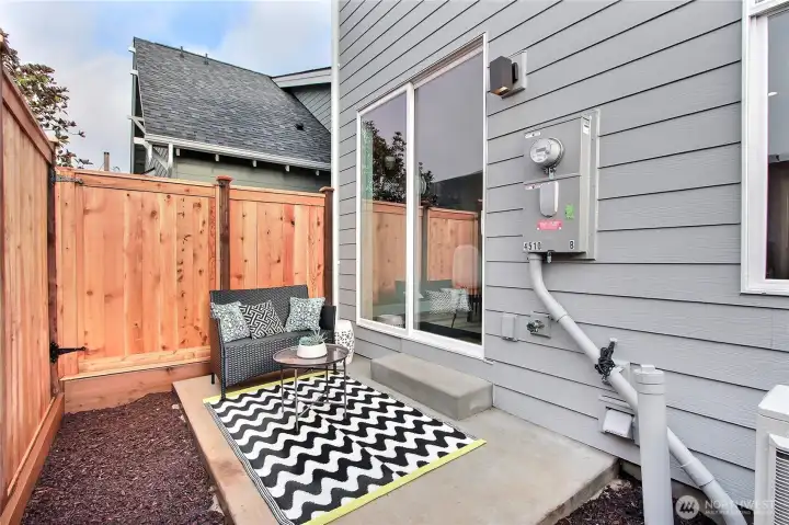 Private patio with 7' fencing and space for an urban garden.