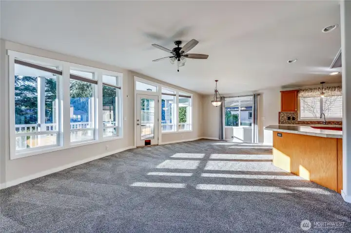 Open floor plan concept, door at center leads to large covered front porch.