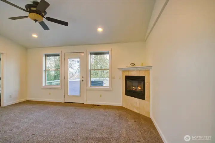Primary bd/w fireplace and door to hot tub/deck