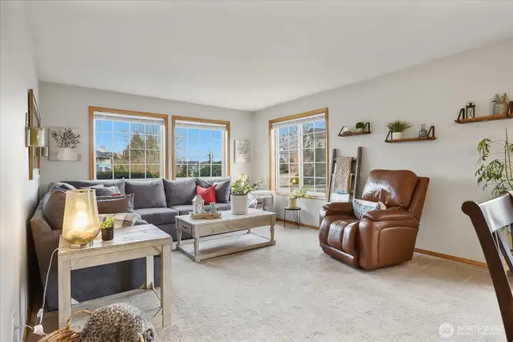 Comfortable living space with large windows letting in natural light.