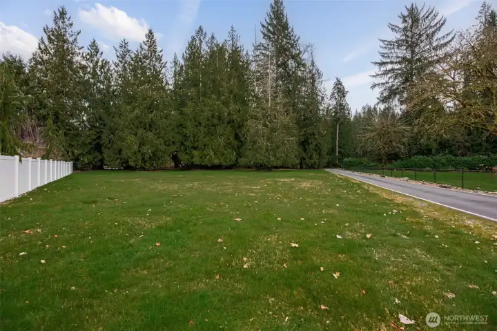 Property from the house goes all the way down to the white fence open field area