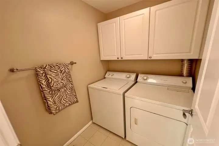 Laundry room with side-by-side washer & dryer (included) and upper cabinets!