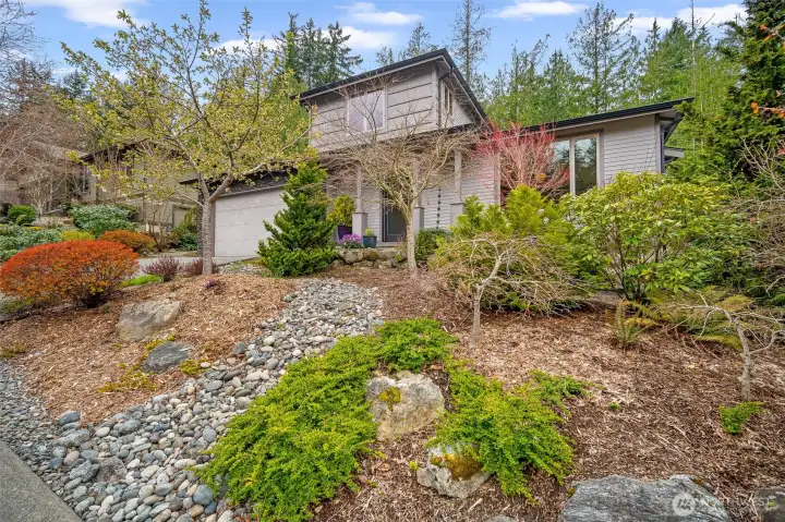 Low-maintenance landscaping, this wooded retreat has timeless Pacific Northwest appeal.