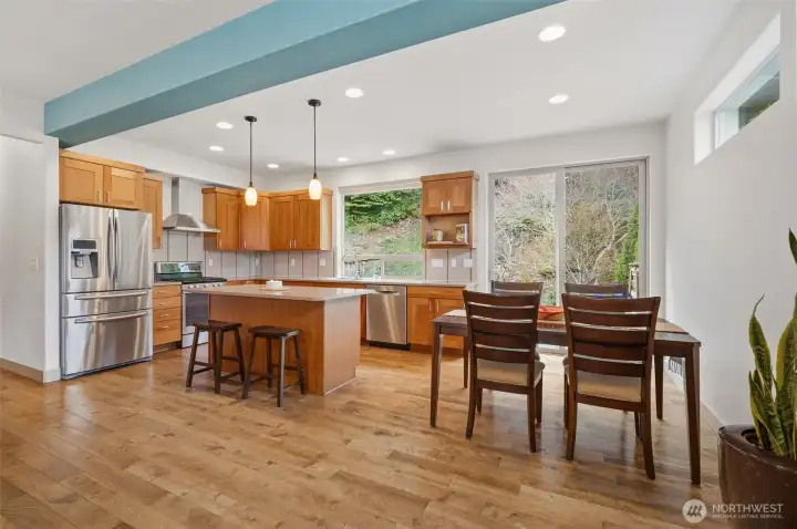 The kitchen and dining area are designed for everyday living with views to the outdoors and access to the patio.