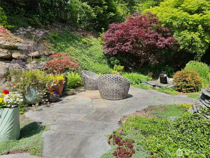 lots of beautiful mature trees and plants in this custom landscape