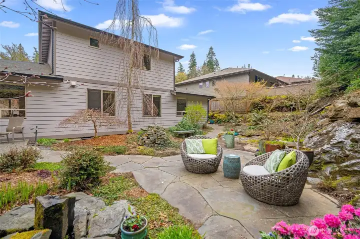Outdoor space framed by the home and surrounding landscape, backing to greenbelt.