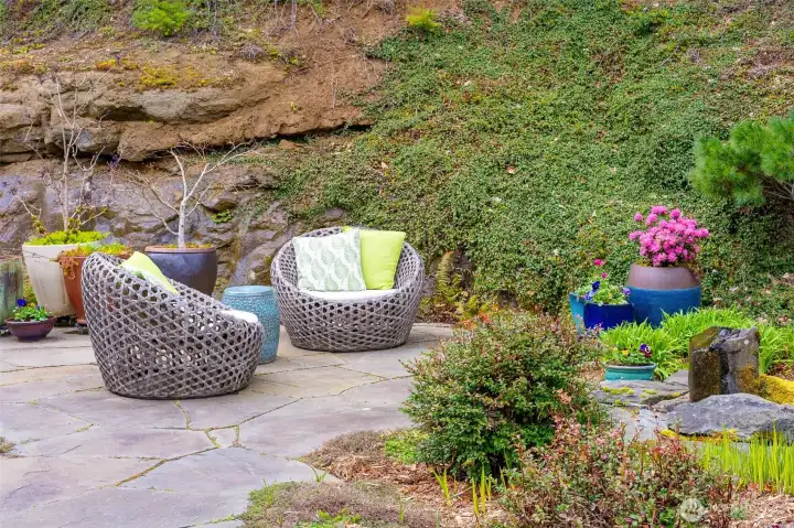 Seating area within a natural garden setting oriented to the water feature.