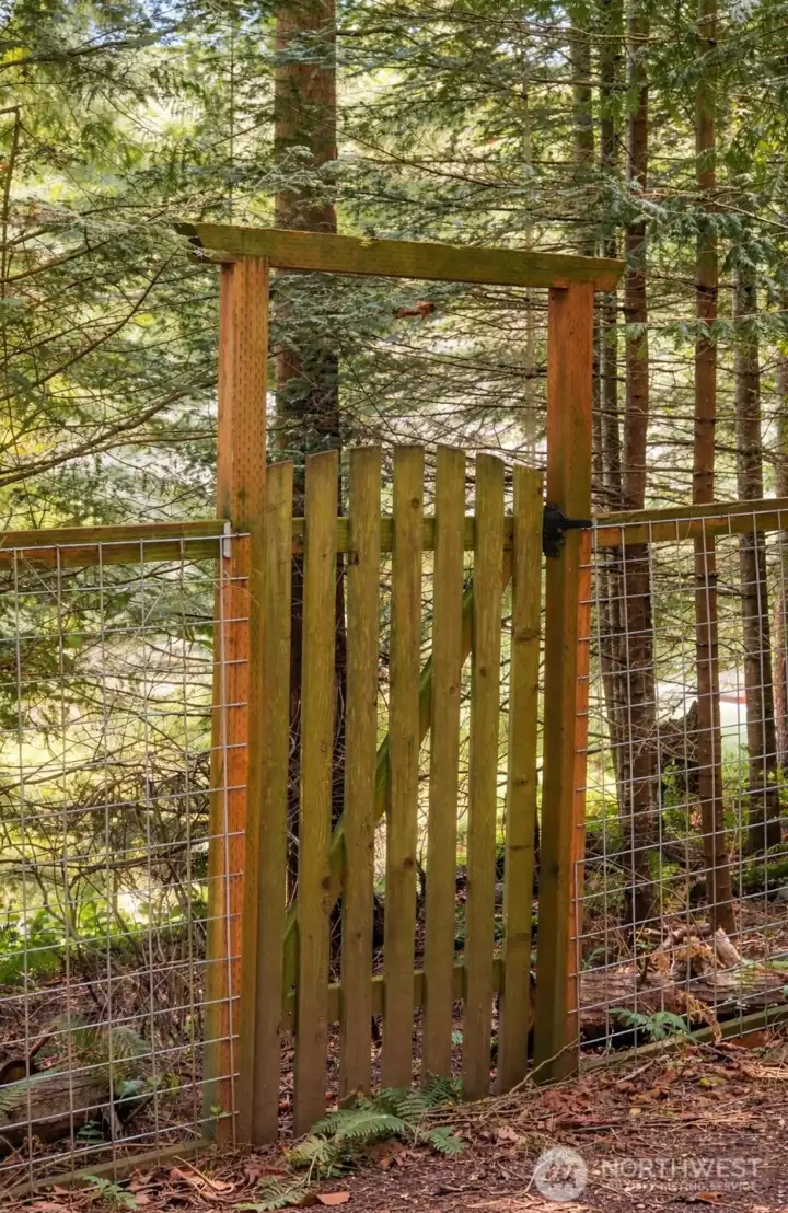 Private garden gate at the rear of the property with potential connection to the surrounding greenbelt.