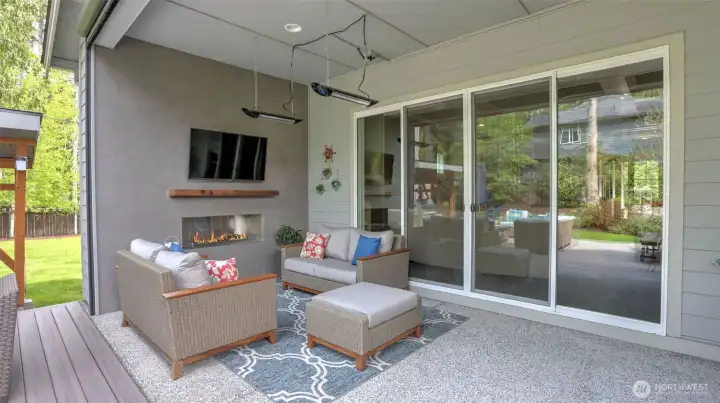 Enjoy the covered outdoor space with LED lit fireplace, built-in heaters, and a privacy screen that retracts from ceiling of outdoor space, keeps heat in and protects from the elements.