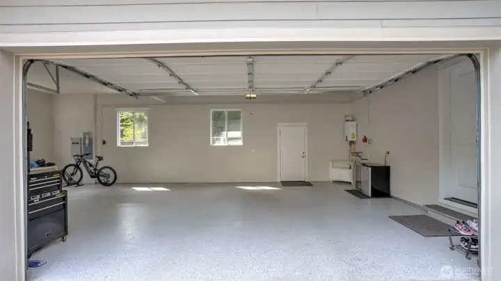 Painted 3 car attached garage with Epoxy poly coated floors