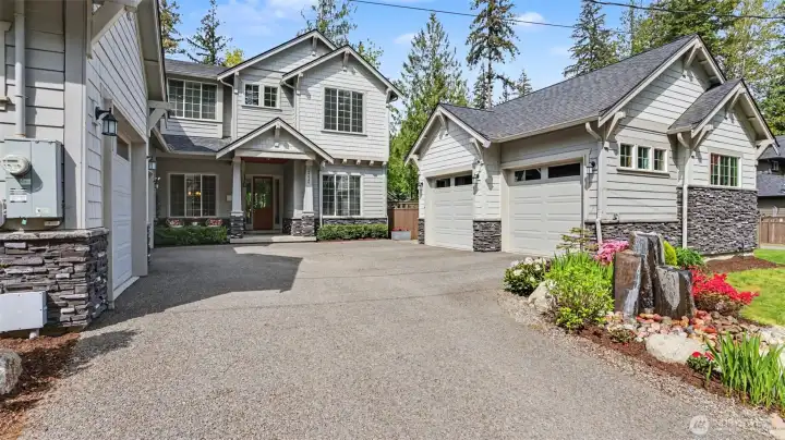 Five covered parking spaces. One attached three car garage and one detached 2 car garage adds an abundance of storage options. Basalt bubbler adds ambience to the front yard space.