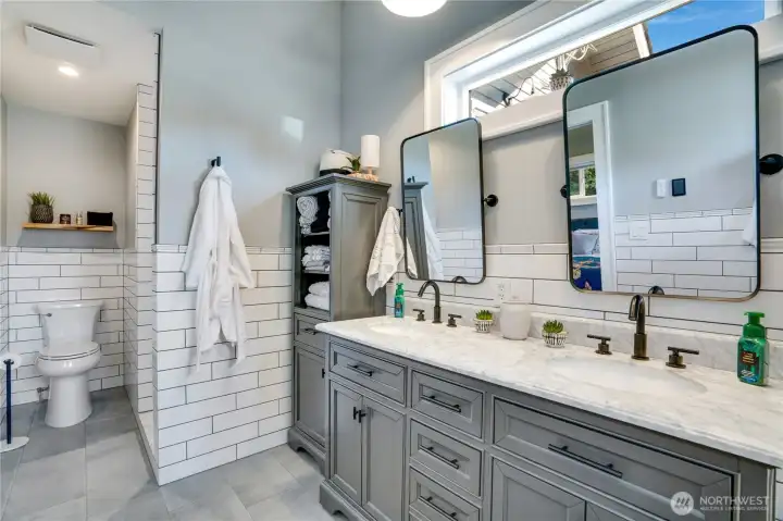 Heated floors, marble countertops, stunning tile work and great lighting.