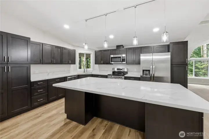 Brand new kitchen with stainless steel appliances and massive counter