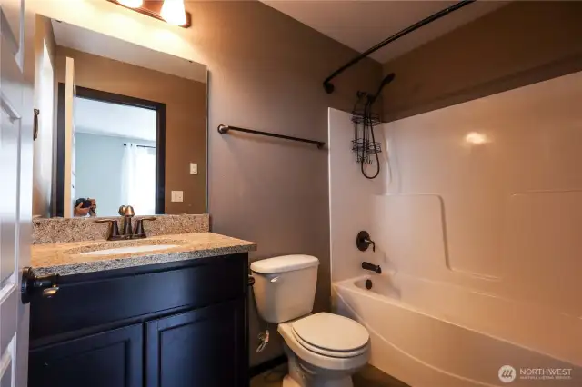 Full bath with tub connected to primary bedroom